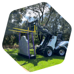 GM-INSTALL-HEADSTONE Small loader installing a headstone and base for difficult to reach areas at MCB cemetery